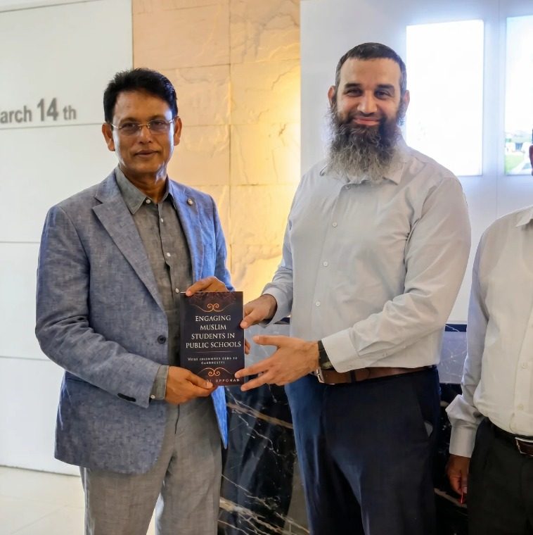 Michael Abraham presenting his book to Ehsanul Hoque Milan, Bangladesh's Minister of Primary and Mass Education